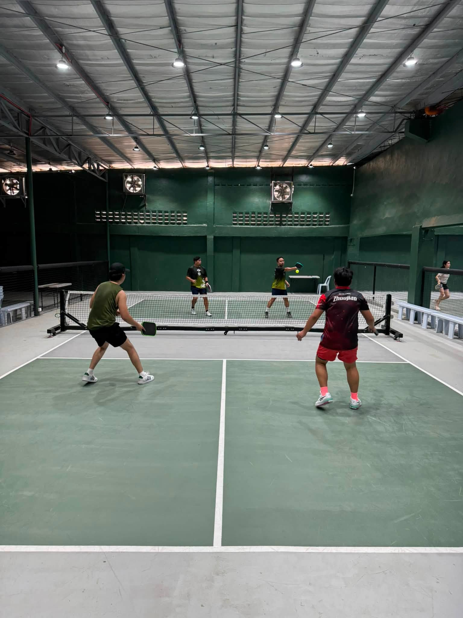 A lively doubles rally at Hoops & Racket